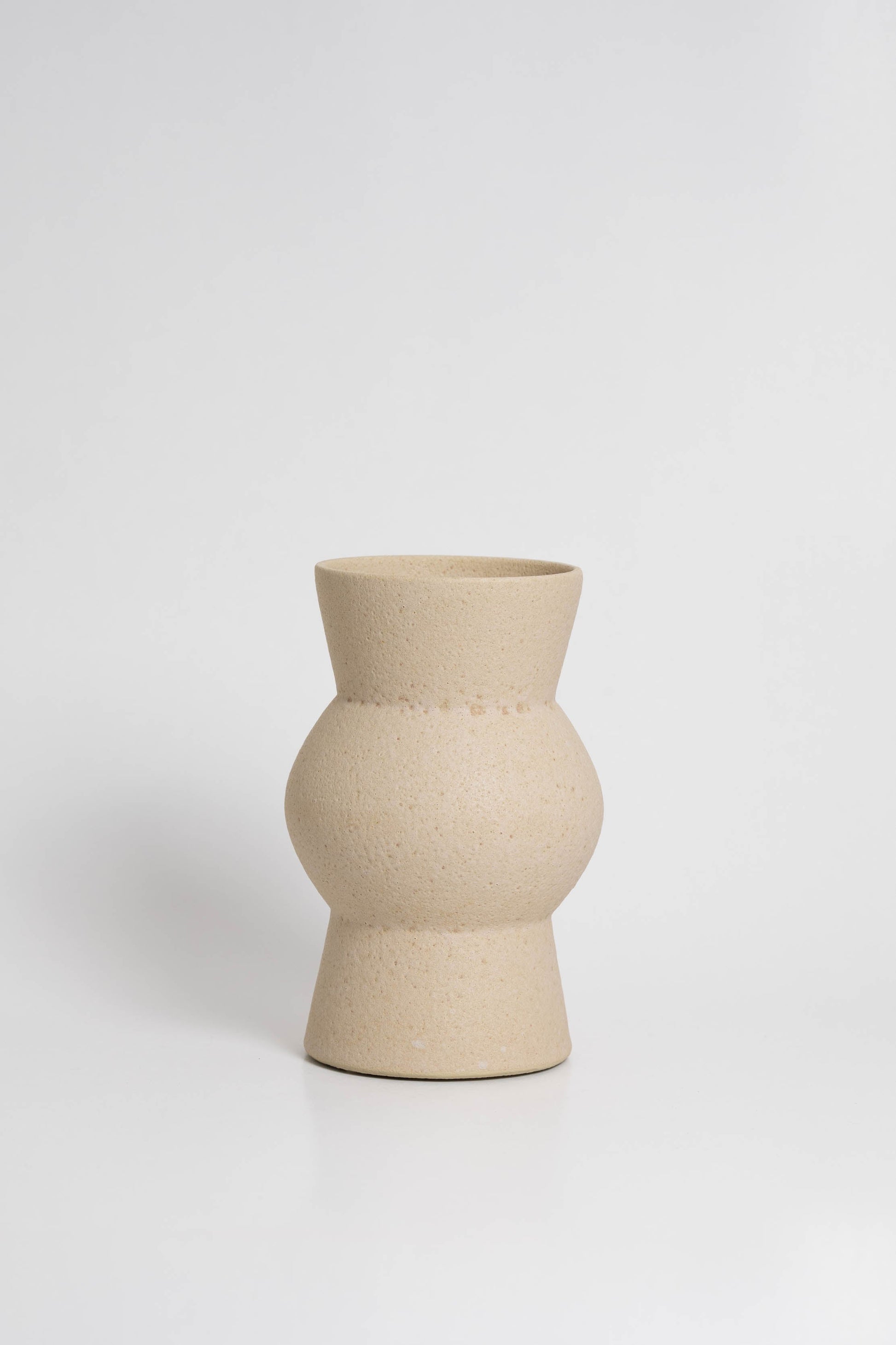 Melas in cream, ceramic vase with a textured, earthy surface, handmade in Portugal. Perfect for displaying flowers or as a unique decorative vase in modern interiors.