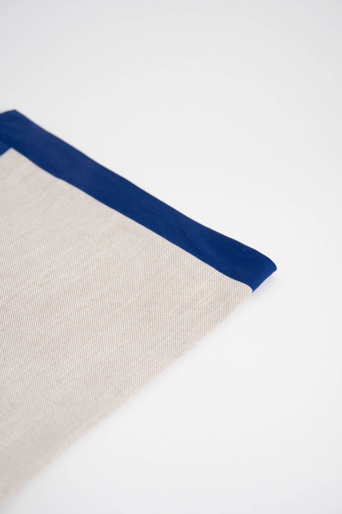 Soft and eco-friendly home textile made from cotton, made in Portugal. Features blue border detail. Perfect for table decor.