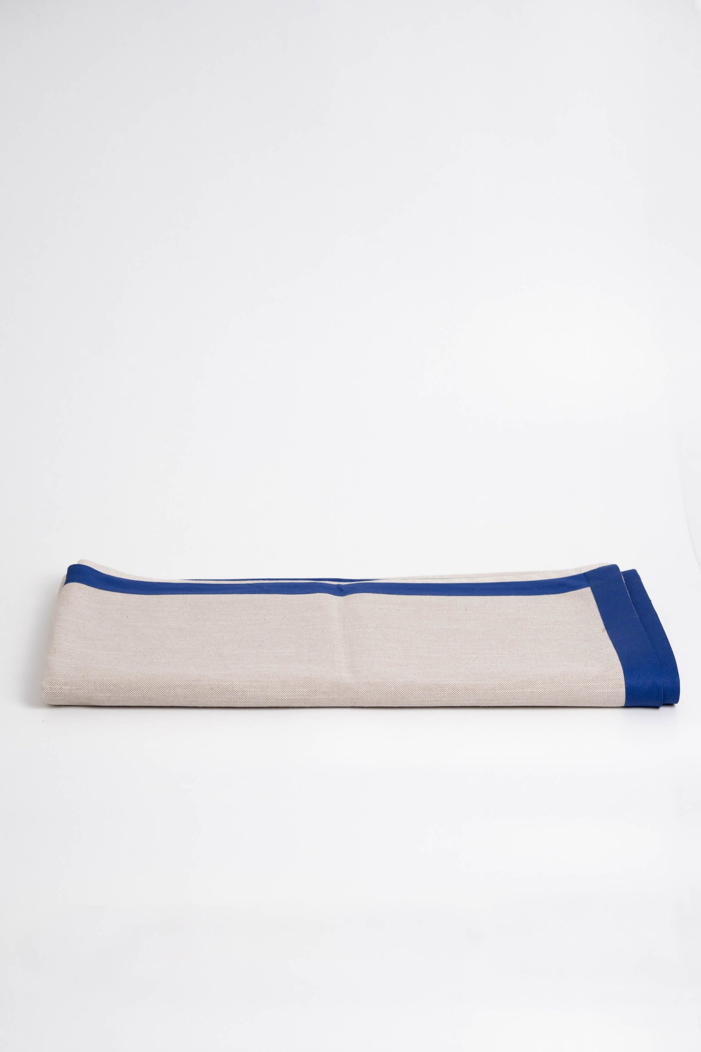 Soft and eco-friendly tablecloth made from cotton, made in Portugal. Features blue border detail. Perfect for table decor.