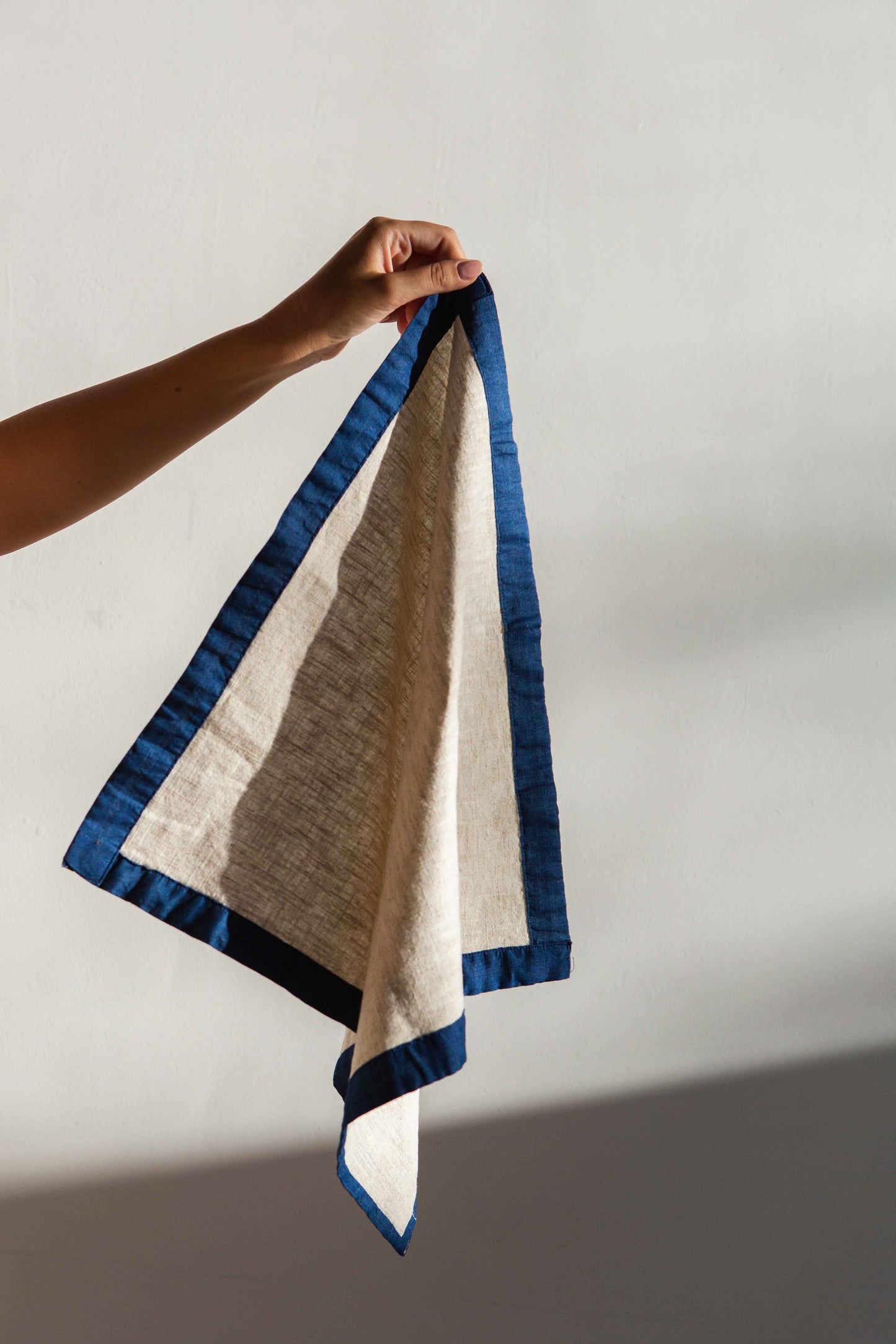 Soft and eco-friendly napkin made from cotton, made in Portugal. Features blue border detail. Perfect for table decor.