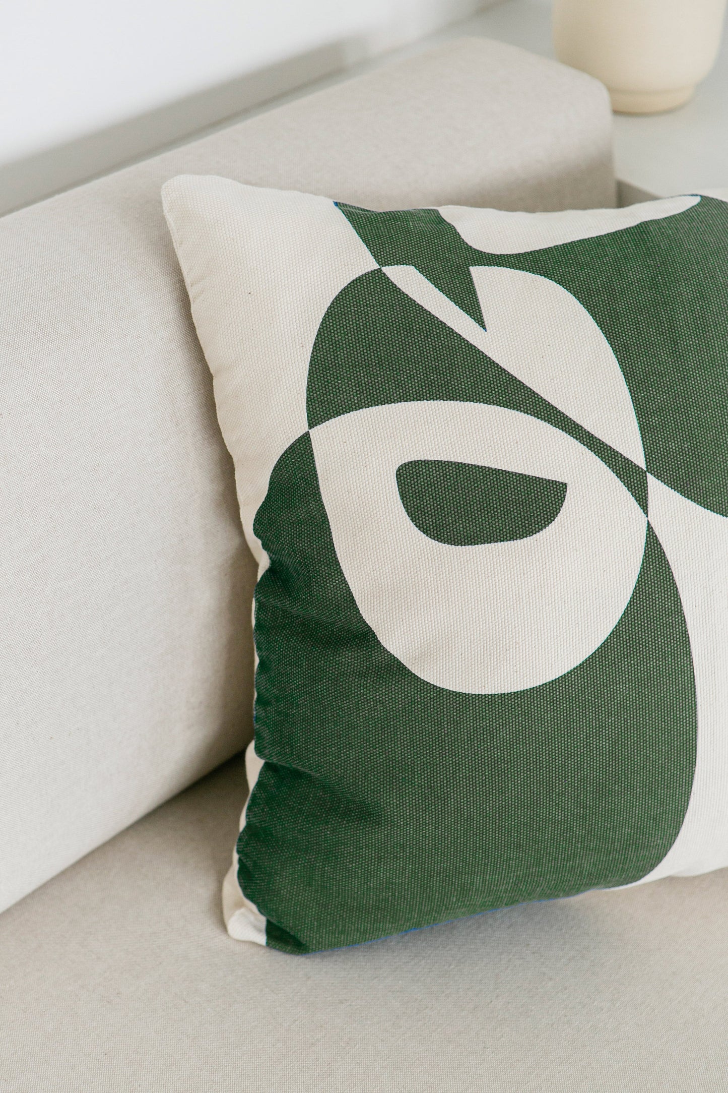 Cotton cushion cover with a vibrant green print, adding a stylish and colorful touch to any sofa or bed. Made in Portugal